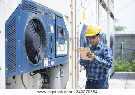 Asian Man Reefer Technician Is Keep Monitoring Temperature For Frozen Cargo By Using Tablet.