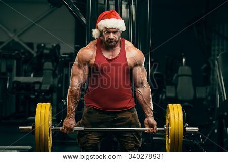 Bodybuilder In Santa Claus Costume In Gym