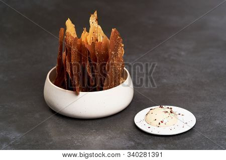 Cereal Chips With Seeds And Kimchi Mayonnaise Sauce On Dark Background