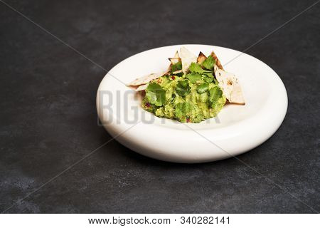 Guacamole With Pita Chips On White Plate. Chef's Signature Dish