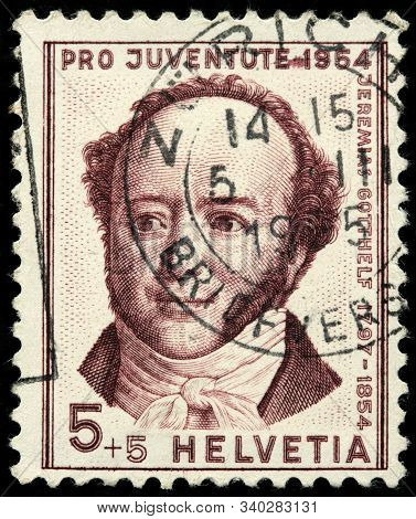 Luga, Russia - October 25, 2019: A Stamp Printed By Switzerland Shows Portrait Of Albert Bitzius - F