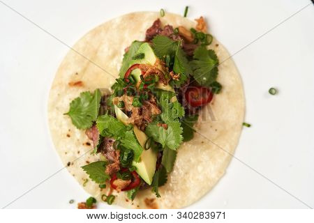 Mexican Tacos With Beef, Tomatoes, Avocado, Chilli And Onion
