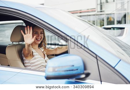 Bye, Gesture. Female Driver Inside Of Modern Automobile. Testing Brand New Car.