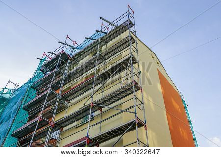 Scaffolding Arround The House To Install Thermal Insulation Of The Apartment Building Facade