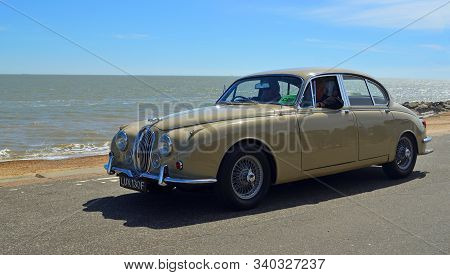 Felixstowe, Suffolk, England - August 29, 2015: Classic Light Brown Jaguar Motor Car Being Driven Al