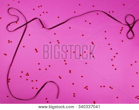 Valentines Day Background. Red Ribbon On A Pink Background With Hearts. Valentines Gift With Ribbon.