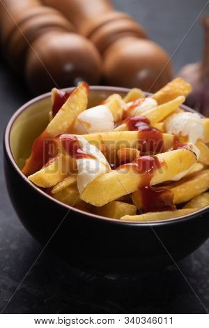Canadian poutine, fried potato chips with cheese and gravy or sauce