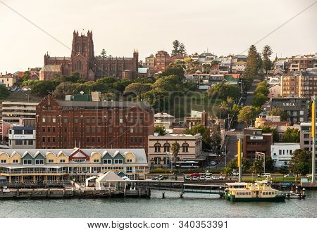 Newcastle, Australia - December 10, 2009: Massive Red Stone Christ Church Cathedral In Its Green Par