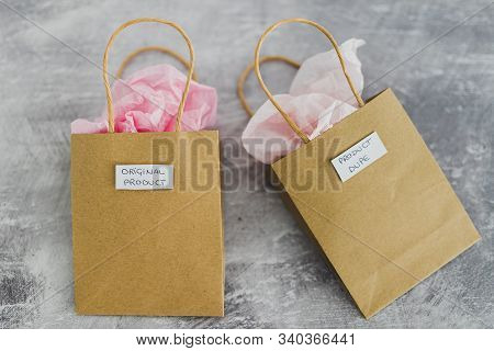 Original Product Vs Dupe Imitation, Shopping Bags With Labels Side By Side With Similar Paper Color