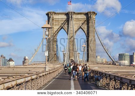 New York, Usa- Jul 9, 2010: Tourists And Residents Cross Brooklyn Bridge In New York City, New York.