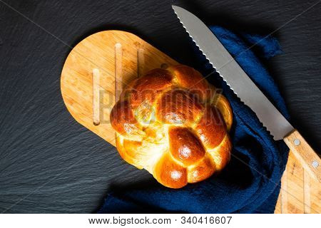 Homemade Food Concept Fresh Baked Bread Braid Challah Or Brioche On Black Slate Stone With Copy Spac