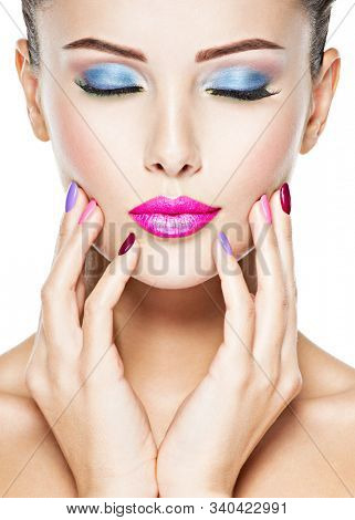 Close-up face of a beautiful woman with fashion makeup . Blu? eye makeup. Pink lips
