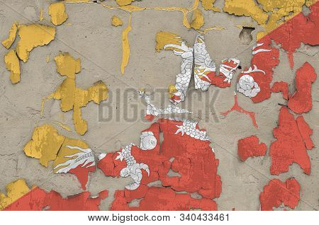 Bhutan Flag Depicted In Paint Colors On Old Obsolete Messy Concrete Wall Closeup. Textured Banner On
