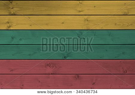 Lithuania Flag Depicted In Bright Paint Colors On Old Wooden Wall. Textured Banner On Rough Backgrou