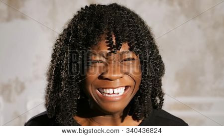 Eal Afro American Lady With Fleecy Hair Screams In Anger And Cries Against White Wall Close View