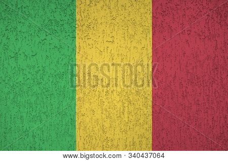 Mali Flag Depicted In Bright Paint Colors On Old Relief Plastering Wall. Textured Banner On Rough Ba
