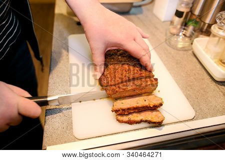 Woman Hands Cutting Piece Of Meatloaf, She Prepare For Tasting Of Food At Kitchen. Chef Cutting Meat