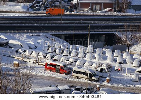 Cars On Parking And Street Covered With Big Snow Layer. View Of Winter And Snowing On City Street Wi