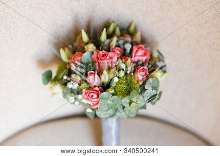 Bride Bouquet Of Eucalyptus Leaves, Roses And Eustom On Beige Background. Accessory For The Bride At