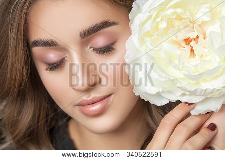 Portrait Of A Beautiful Happy Woman With Clean Skin And Beautiful Nude Make-up. Beautiful Eyes Close