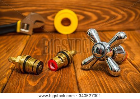 Cruciform Hot And Cold Water Main Switch Of Spare Parts On Vintage Wooden Boards