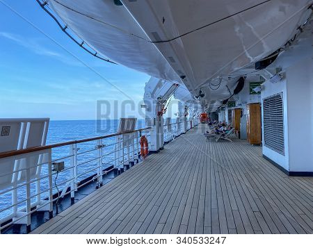 Ft. Lauderdale,fl/usa-11/1/19: A Group Of Passengers Lounging In Chairs Under The Life Rafts On The 