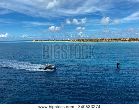 Aruba-11/2/19: A Pilot Boat Escorting A Cruise Ship Into The Aruba Port With A View Of The Coastline