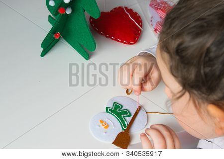The Hand Of The Child Make Snowman And Christmas Tree With Needle, Thread For Christmas Greeting Car