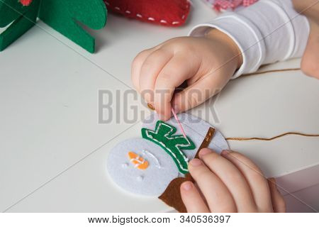 The Hand Of The Child Make Snowman And Christmas Tree With Needle, Thread For Christmas Greeting Car
