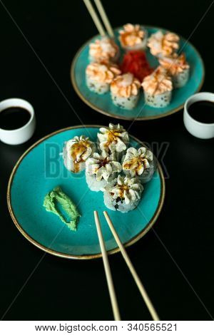 Sushi Rolls In Blue Plate, Chopsticks, Soy Sauce, Ginger And Wasabi. Focus And Unfocus.