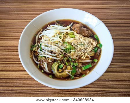 Braised Chicken With Bitter Gourd Noodle On Wooden Background