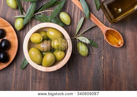 Olives, Oilive Oil And Brunches On The Wooden Table,