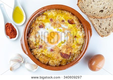 Garlic And Bread Soup (castilian, From Spain) In Clay Pot And Its Main Ingredients. View From Above.