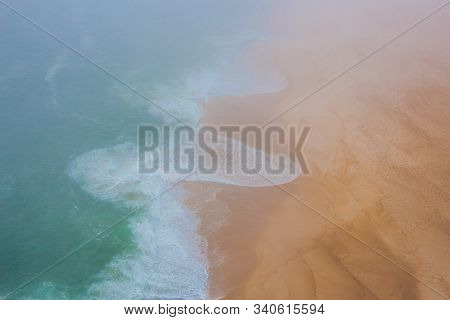 Sea And Sandy Beach In Dense Fog, Autumn Day
