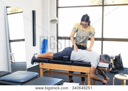 Man Having Chiropractic Back Adjustment. Physioterapy, Osteopathy, Alternative Medicine Pain Relief 