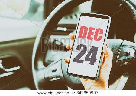 December 24th. Day 24 Of Month, Calendar Date. Month And Day Placed On A Smartphone Screen In Womans