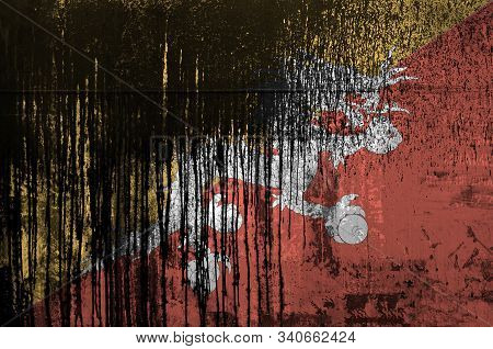 Bhutan Flag Depicted In Paint Colors On Old And Dirty Oil Barrel Wall Closeup. Textured Banner On Ro