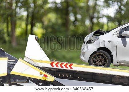 Accident Car Slide On Truck For Move. White Car Have Damage By Accident On Road Take With Slide Truc