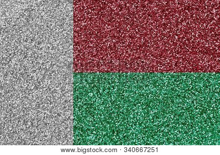 Madagascar Flag Depicted On Many Small Shiny Sequins. Colorful Festival Background For Party