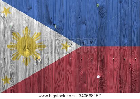Philippines Flag Depicted In Bright Paint Colors On Old Wooden Wall. Textured Banner On Rough Backgr