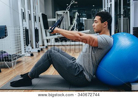 Kinesitherapy, A Mixed Race Man Is Training In A Wellness Center, On Special Simulators
