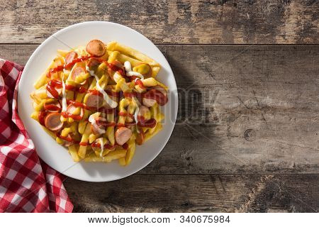 Typical Latin America Salchipapa. Sausages With Fries, Ketchup.  Top View. Copy Space