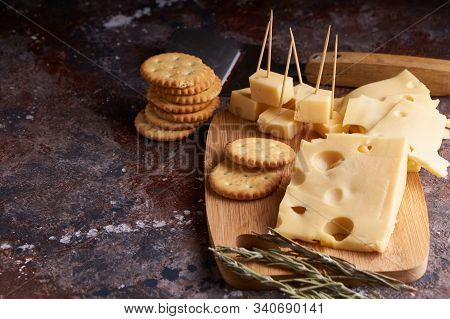 Pieces Of Cheese, Nuts, Raisins, Snacks For Wine On A Wooden Background. Appetitive