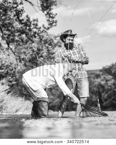 Enjoying Time Together. Fly Fish Hobby Of Businessman. Retirement Fishery. Two Male Friends Fishing 