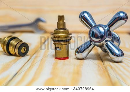 Cruciform Hot And Cold Water Main Switch Of Spare Parts On Wooden Boards