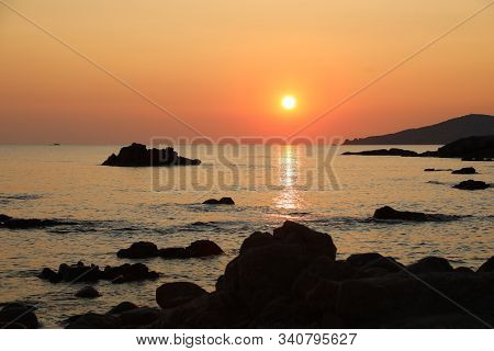 Red Sun At Sunset With Reflect On The Water Of Ocean