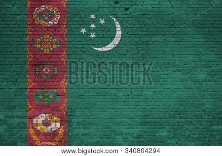 Turkmenistan Flag Depicted In Paint Colors On Old Brick Wall. Textured Banner On Big Brick Wall Maso