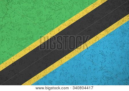 Tanzania Flag Depicted In Bright Paint Colors On Old Relief Plastering Wall. Textured Banner On Roug