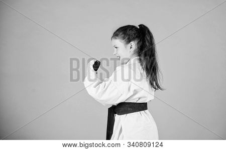 Power And Balance. Sport Success In Single Combat. Small Girl In Martial Arts Uniform. Practicing Ku