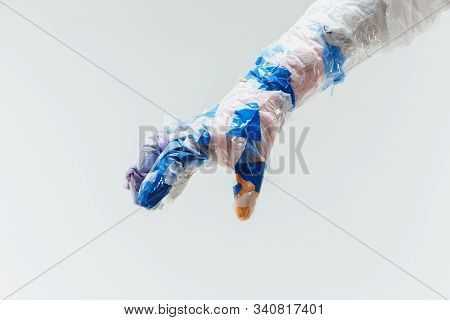 Big Plastic Hand Made Of Garbage Isolated On White Studio Background. The Result Of Polymers Overusi